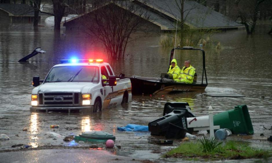 Bossier Parish Sherrif's deputies search for people that may be stranded in the homes in Shreveport, La., on Wednesday, March 9, 2016. Dozens of homes were flooded and scores of residents were evacuated. Photo: Douglas Collier, The Shreveport Times via AP