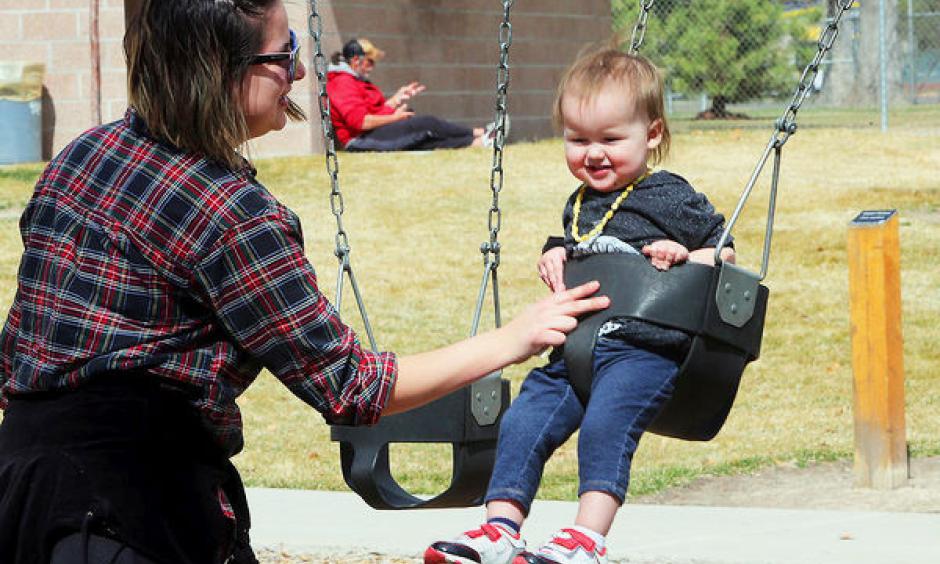 Victoria Westfall of Grand Junction, pushes her son, Isildur Westfall, on the swings at Lincoln Park on a warm afternoon. Photo: Daily Sentinel