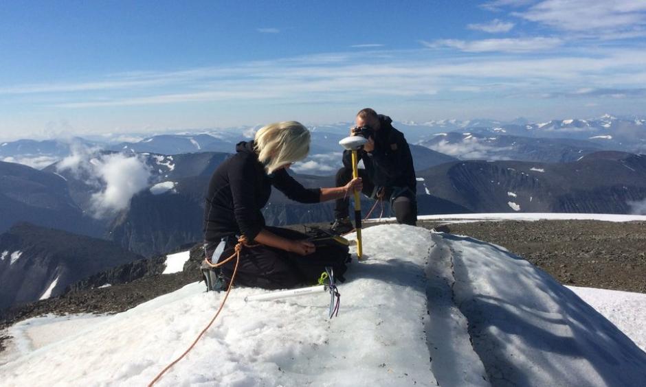 Gunhild Rosqvist, a Stockholm University geography professor, making measurements atop the southern tip of Kebnekaise, formerly Sweden’s highest peak. Photo: Carl Lundberg, Stockholm University, via Agence France-Presse/Getty Images