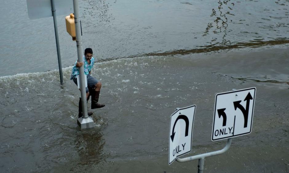 Evading a wave in Houston after Hurricane Harvey hit on Aug. 25. Photo: Brendan Smialowski, Agence France-Presse/Getty Images