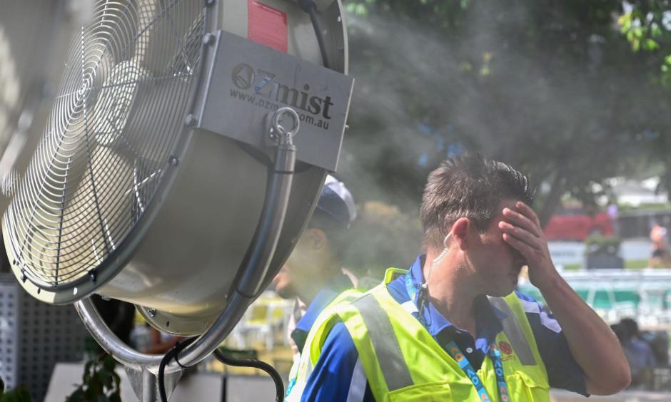 A man cools down in front of a mist fan for relief from the hot weather in Melbourne on Jan. 25, 2019. Photo: Saeed Khan, AFP/Getty Images