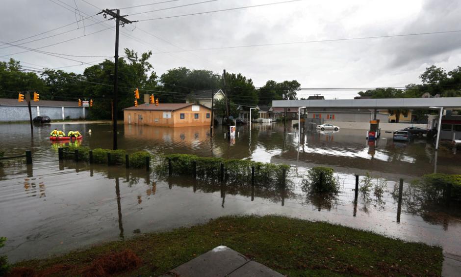 Rescue crews cross through the intersection of King St. and Huger St. after heavy rain on Tuesday, May 23, 2017. Photo: Michael Pronzato