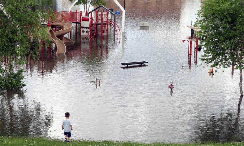 The rising Mississippi River covered a playground and closed roads on Tuesday in St. Paul. Photo: Jim Mone, Associated Press