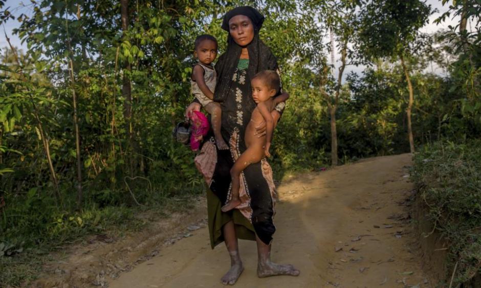A Rohingya Muslim woman Zahida Banoo holds her son Mohammad Noor, left, and daughter Shah Heer as she poses for a photograph on the way to her shelter in Kutupalong refugee camp, Bangladesh, Friday, Sept. 15, 2017. Those packed into camps and makeshift settlements in Bangladesh are becoming desperate for scant basic resources as hunger and illness soared. Photo: AP