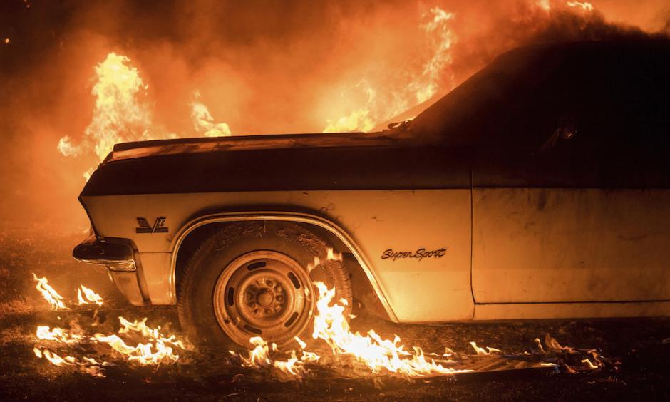 Flames from the Wall Fire consume a vintage Chevrolet Super Sport near Oroville. Photo: NBC Southern California via AP