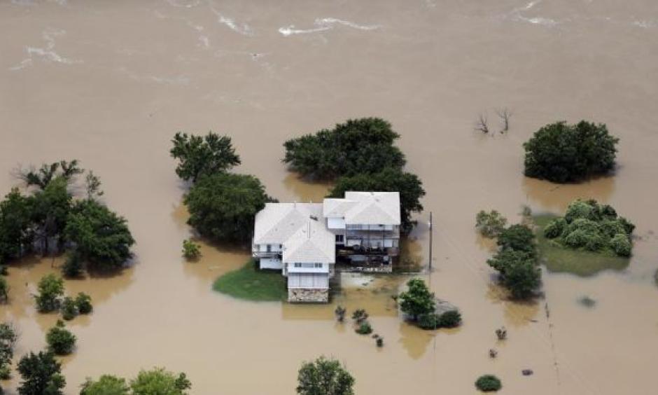 Flood waters from the Brazos River surround a home in Weatherford, Texas on Friday, May 29th. Photo: Brandon Wade, AP
