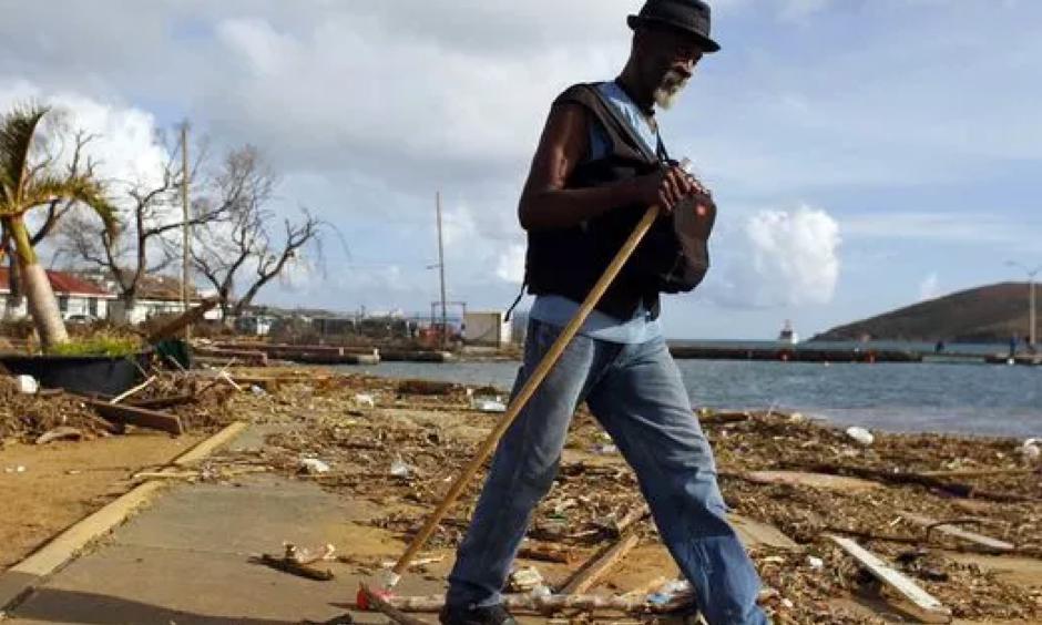 A man walks past debris caused by Hurricane Irma in Charlotte Amalie, St. Thomas, U.S. Virgin Islands, on Sept. 10, 2017. The storm ravaged such lush resort islands as St. Martin, St. Barts, St. Thomas, Barbuda and Anguilla. Photo: Ricardo Arduengo, AP