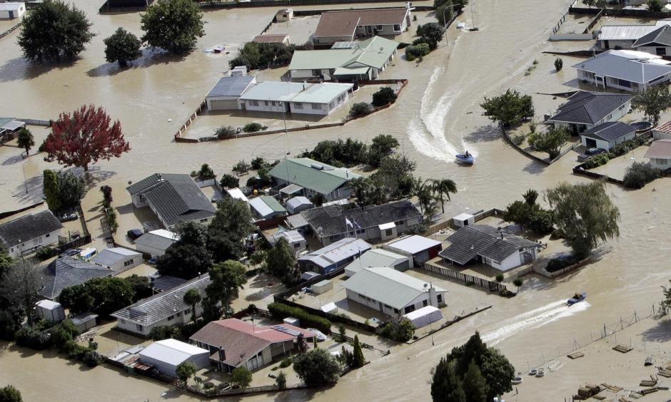Jet boats drive through the flooded streets of the North Island town of Edgecumbe in New Zealand Andrew Warner/The Bay of Plenty Times/AP