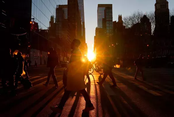 Pedestrians walk up 6th Avenue as the sun rises along 42nd Street, Jan. 2, 2024, in New York. (Credit: Gary Hershorn/Getty Images via ABC)