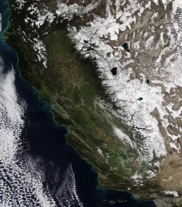 Satellite image shows snow-capped mountains over the western United States. (Credit: NASA, via USA Today)