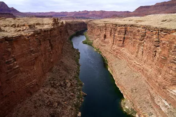 FILE - The Colorado River flows in Lees Ferry, Ariz., on May 29, 2021. Arizona, California and Nevada on Monday, May 22, 2023, proposed a plan to reduce their water use from the drought-stricken Colorado River over the next three years, a potential breakthrough in a year-long stalemate that pitted Western states against one another. (Credit: AP Photo/Ross D. Franklin, File)