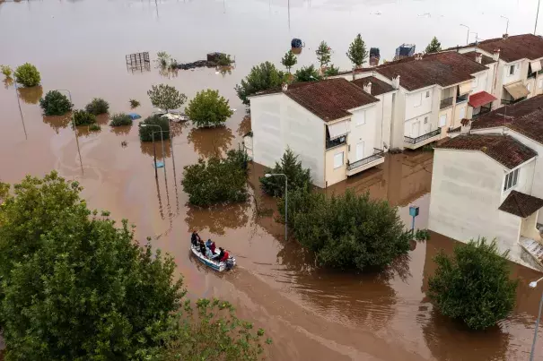 People on a boat help residents move through floodwater following heavy rains caused by Storm Daniel in Greece. (Credit: Konstantinos Tsakalidis/Bloomberg)