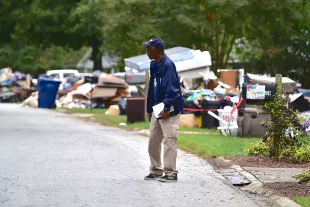 FEMA Disaster Survivor Assistance team member James Mason walks through a Lexington, S.C., neighborhood hit hard by severe flooding in October. Photo: Bill Koplitz, FEMA