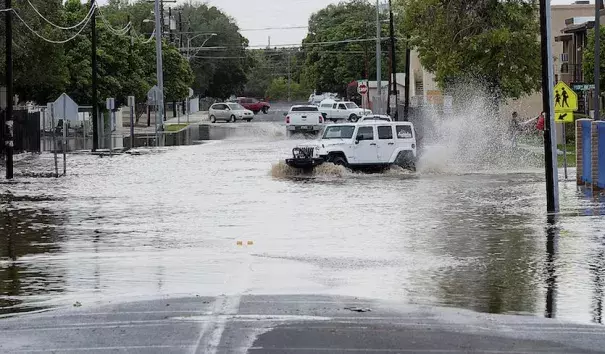 Vehicles navigate a flooded 5th Street in Yuma, Ariz., after an early-afternoon rainstorm on Sunday, Sept. 30, 2018. Yuma picked up 0.65” of rain on Sunday and 0.26” on Monday. The storm total of 0.91” compares to Yuma’s annual average (1981-2010) of just 3.56”. One station in northern Yuma recorded 2.77” over the past two days, amounting to about three-quarters of the average annual rainfall. Photo: Randy Hoeft, Yuma Sun via AP