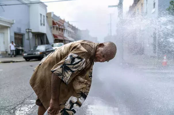 Eduardo Velev cools off in the spray of a fire hydrant in Philadelphia during a July 2018 heat wave. Scientists say last summer's extreme heat across the Northern Hemisphere wouldn’t have happened without human-induced climate change. Photo: Jessica Kourkounis, Getty Images