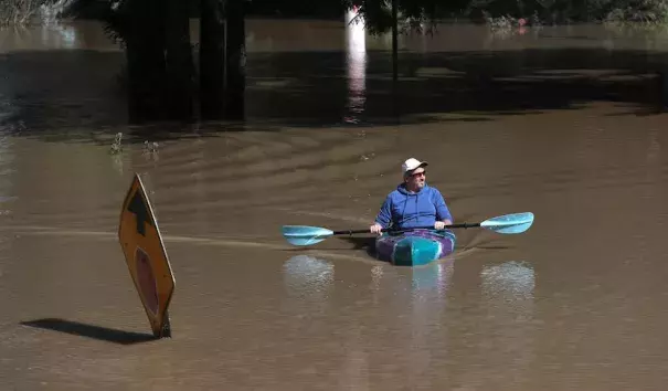 On the last day of meteorological winter—February 28, 2019—a kayaker paddles through a flooded neighborhood in Guerneville, California. The town was under mandatory evacuation and roads leading into the town have been flooded over, after an atmospheric river event brought torrential rains to central California and inundated the Sierra with heavy snow. Photo: Justin Sullivan, Getty Images