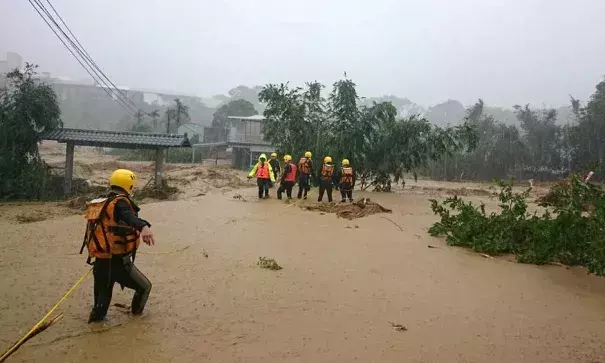 Rescue workers keep a wary eye on a mudslide in the aftermath of Typhoon Soudelor in Taiwan. The island's military put tens of thousands of troops and thousands of vehicles on stand-by for rescue operations. Photo: Xinhua, REX Shutterstock