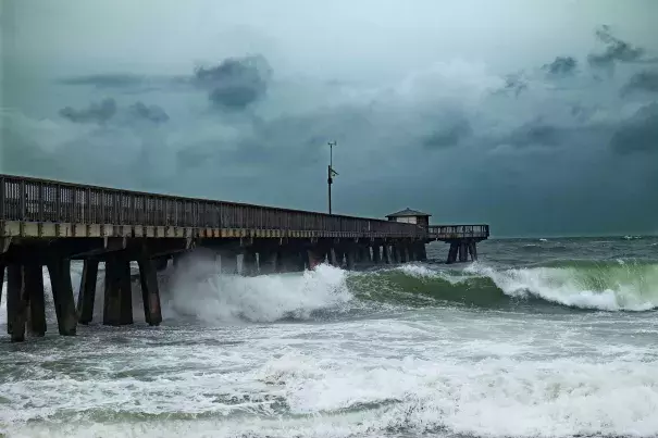 Waves pound a pier on Pompano Beach, Florida, spurred by Hurricane Matthew. The state is ill-prepared for rising seas, experts warn. Photo: Gaston de Cardenas, AFP Getty