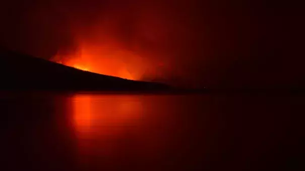 A night view of the Howe Ridge Fire on the shores of Lake McDonald. Photo: Glacier National Park