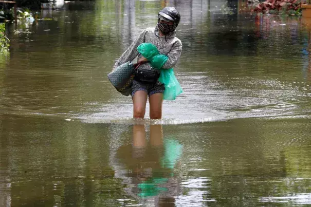 A woman wades through a flooded village after heavy rainfall caused by tropical storm Son Tinh in Ninh Binh province, Vietnam, July 22, 2018. Photo: Reuters/Kham