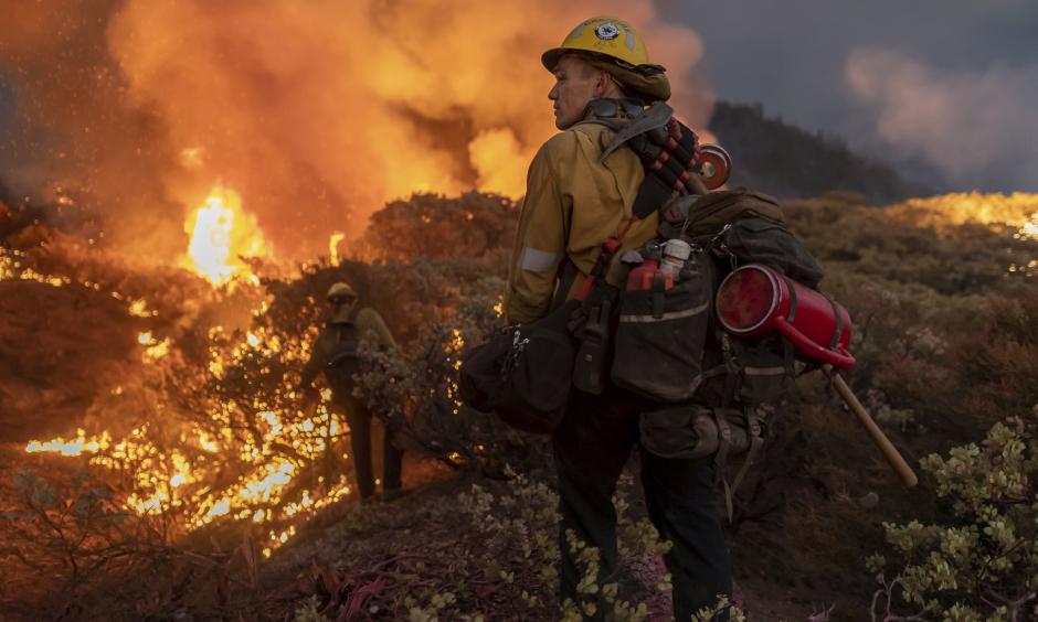 Firefighters battle the Caldor fire on August 22, 2021.