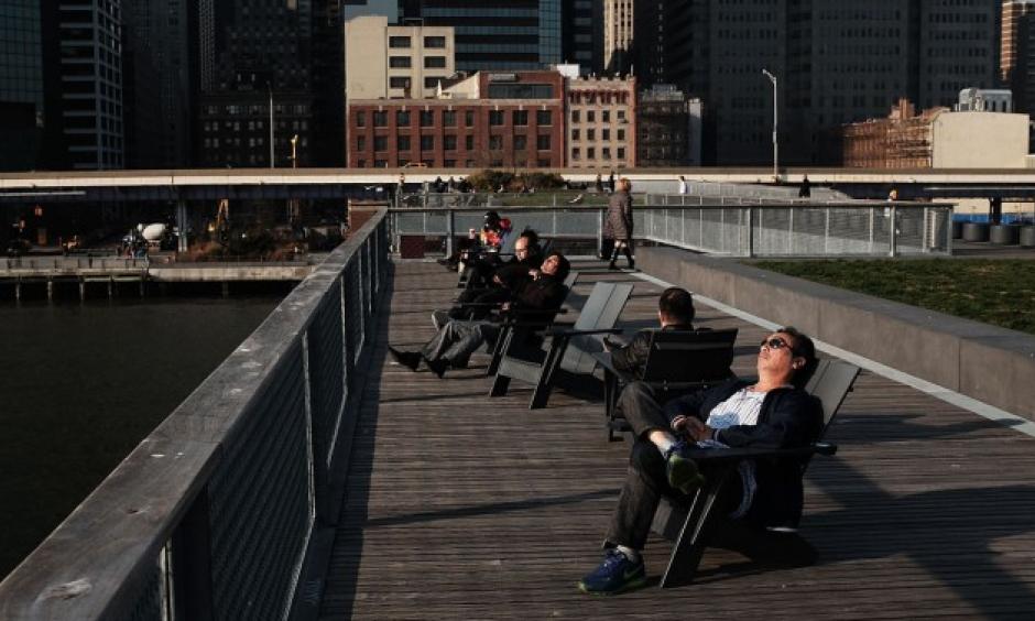 People enjoy unseasonably warm weather in lower Manhattan in December. Photo: Getty