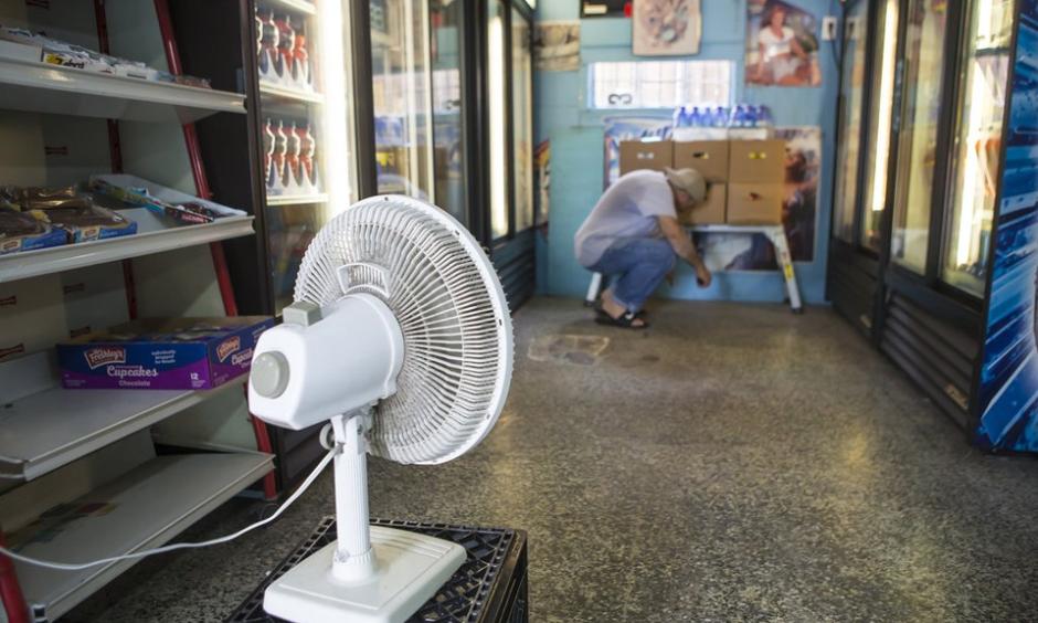 Fadi Abuali, owner of Busy Bee Food Store on Orleans Avenue, uses a small fan to dry out his store in New Orleans on Sunday, August 6, 2017 following an unexpectedly heavy rain on Saturday. He said he stayed at his store till 2 am because he couldn't leave due to the flooded streets. Photo: Chris Granger, NOLA.com | The Times-Picayune