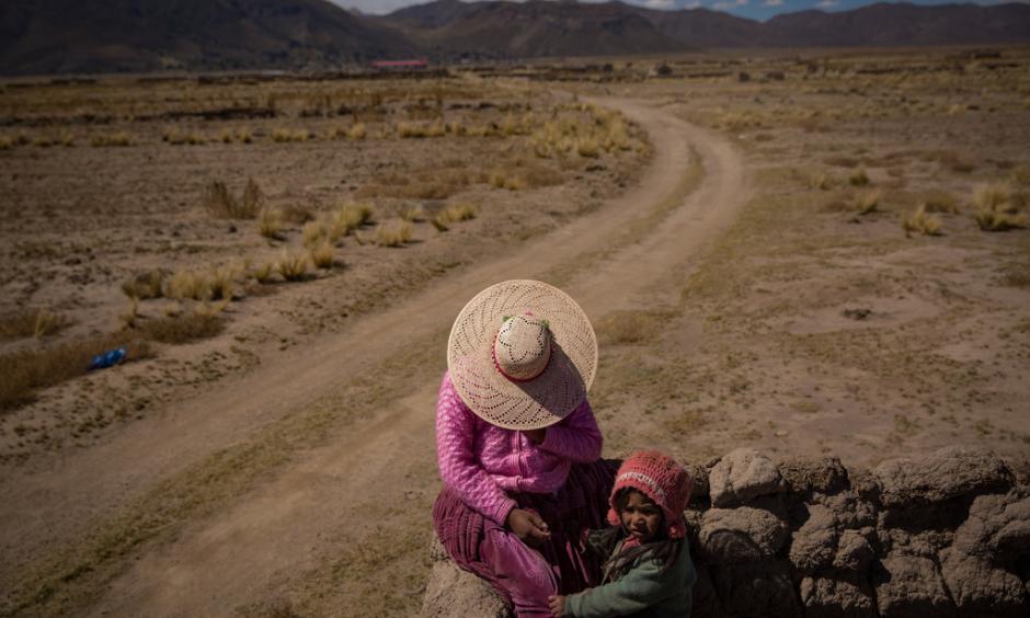 Agustina Rios Moya, 22, with her daughter in the ruins of a family house. Photo: New York Times