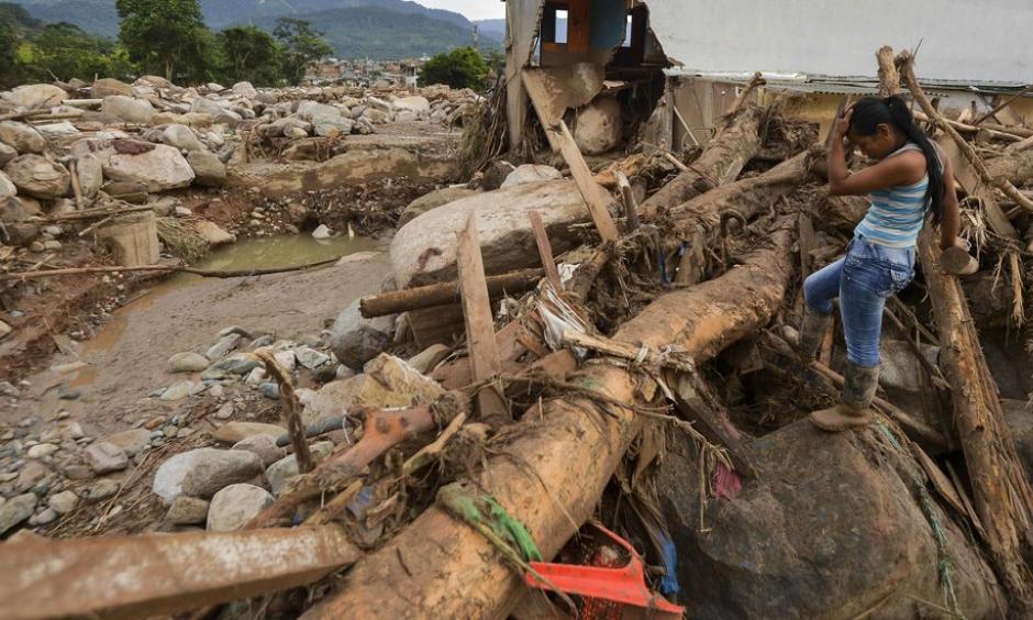 A survivor on Sunday amid the damage caused by a mudslide after heavy rains in Mocoa, Colombia. Photo: Credit Luis Robayo, Agence France-Presse