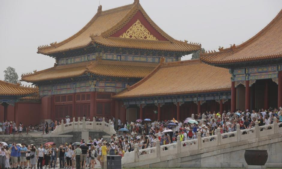 Tourists visit the Forbidden City in Beijing in early July. Photo: Wu Hong/European Pressphoto Agency