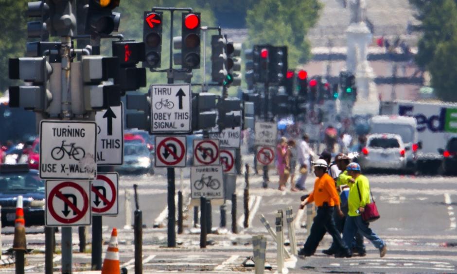 Construction workers cross Pennsylvania Avenue as the temperature reaches 98 degrees Fahrenheit in Washington on Monday. Photo: Jim Lo Scalzo / European Pressphoto Agency
