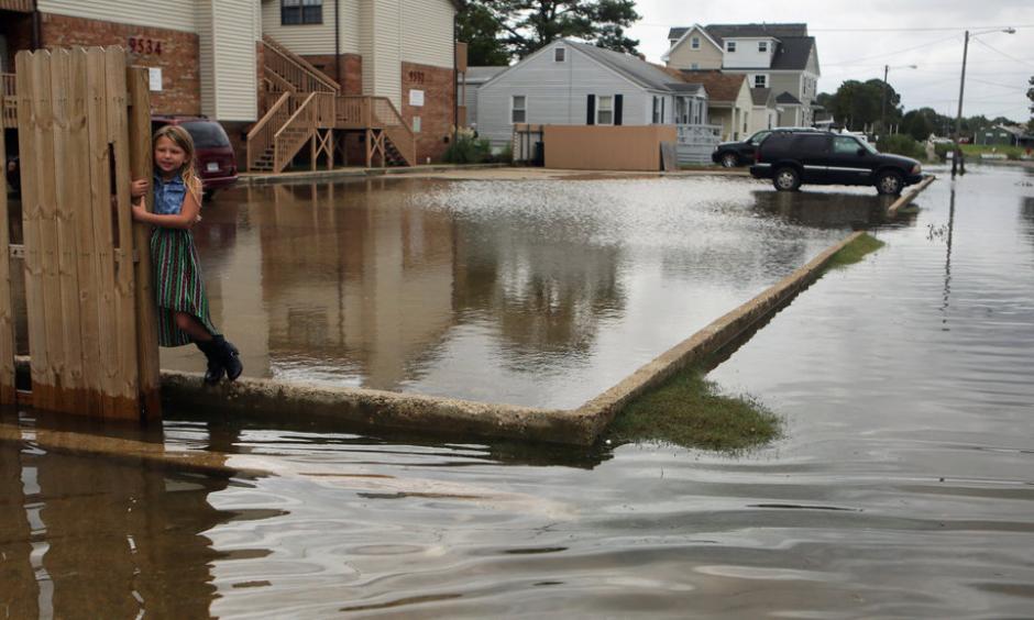 Chloe Riffle, 7, on a flooded street in Norfolk, Va., on Sunday. Photo: Vicki Cronis-Nohe/The Virginian-Pilot, via Associated Press