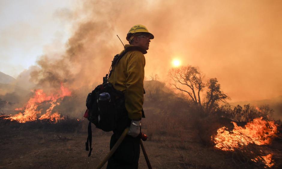 An air tanker drops fire retardant on homes threatened by the Sand Fire as firefighters continue to battle the Sand Fire on Monday, July 25, 2016. Photo: RMG News