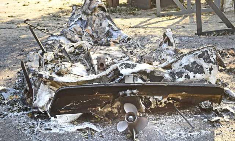 The propeller remains attached to the hull of a fiberglass motor boat that melted in the flames of the Sand Fire. Photo: Dan Watson