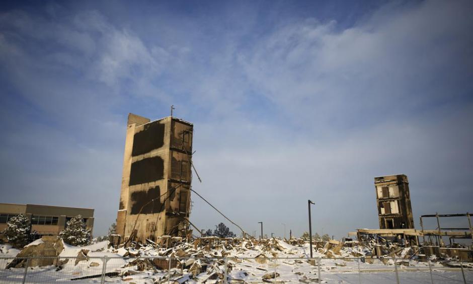 The charred remains of an Element Hotel destroyed by wildfires Thursday, Jan. 6, 2022, in Superior, Colo. Colorado authorities said Thursday, that last week's wildfires caused $513 million in damage and destroyed 1,084 homes and structures. (AP Photo/David Zalubowski)
