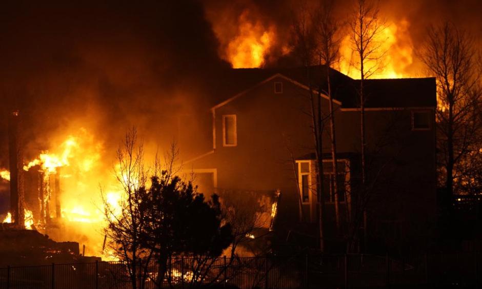 Homes burn as wildfires rip through a development Thursday, Dec. 30, 2021, in Superior, Colo. (AP Photo/David Zalubowski)