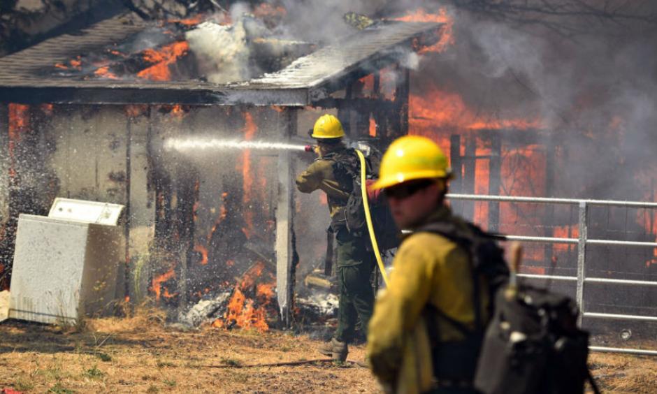 Firefighters battle flames as a house burns in Lower Lake, Calif., in August 2016. Photo: Josh Edelson, AP
