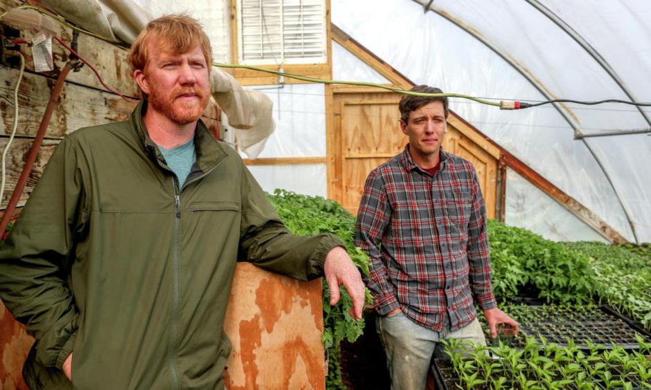 Rick Dalen (left) with Northern Harvest Farm and Adam Kemp with Uff-da Organics and Northern Harvest Farm talk about sustainable farming practices in a greenhouse at Northern Harvest Farm near Wrenshall. Photo: Clint Austin