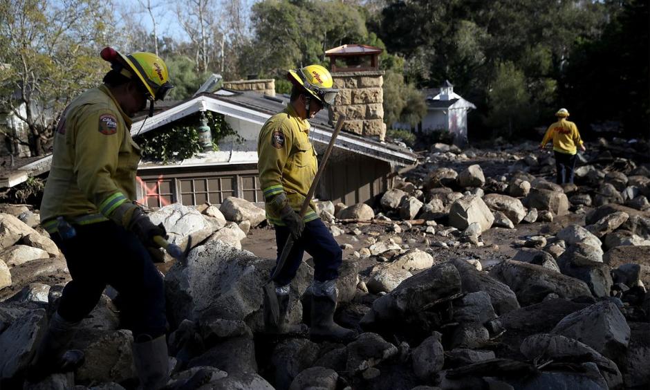 Firefighters search for people trapped in mudslide debris in Montecito, California in 2018.