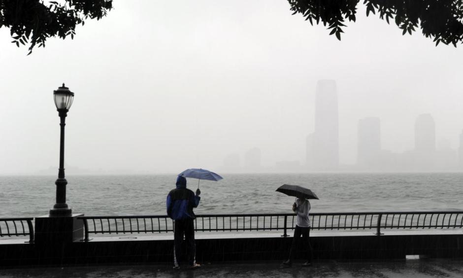 A couple looks at the view of New Jersey from Battery Park in Lower Manhattan on Aug. 28, 2011, as Hurricane Irene hit the region with rain and high winds. Coastal flooding from this week's blizzard may match or exceed Irene's levels. Photo: Stan Honda, AFP/Getty Images