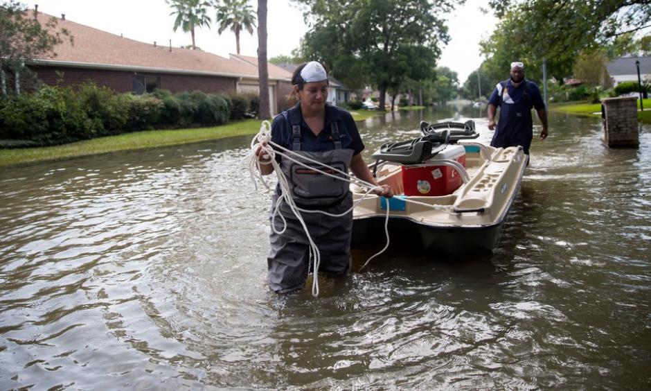 Lisa Montemayor, an environmental investigator with the Houston Health Department, and Jesse Crain III, an environmental assessor with the Environmental Health Service at the Baylor College of Medicine, collecting water samples last week in Houston neighborhoods affected by flooding from Hurricane Harvey. Photo: Eric Thayer, The New York Times