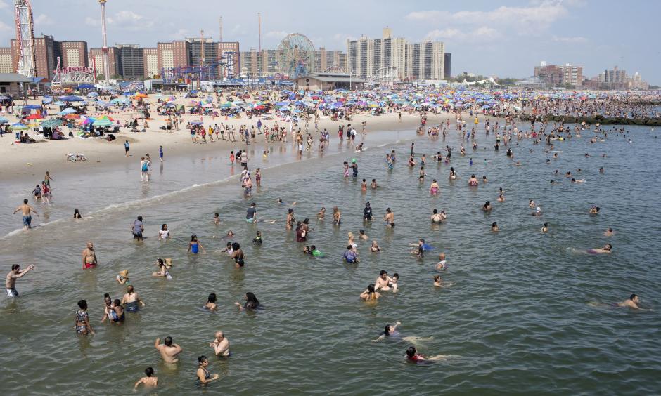 People seek refuge from the searing heat at the beach in Coney Island, New York City. Credit: Andrew Lichtenstein, Corbis via Getty Images