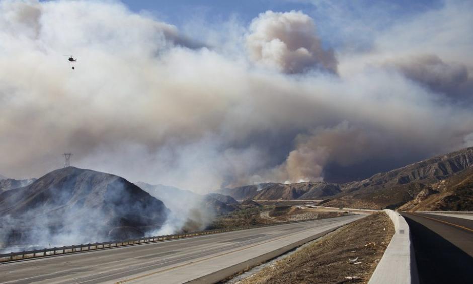 As of Tuesday night, more than 80,000 people had to evacuate because of the fire. Photo: Reuters and KESQ via Associated Press