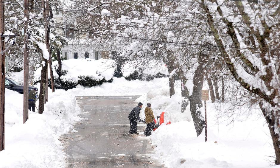Neighbors dig out a driveway on Rockhill Street in Foxboro, Massachusetts, Monday, March 4, 2019, after the area received well over a foot of snow in an overnight storm. Photo: Mark Stockwell, AP