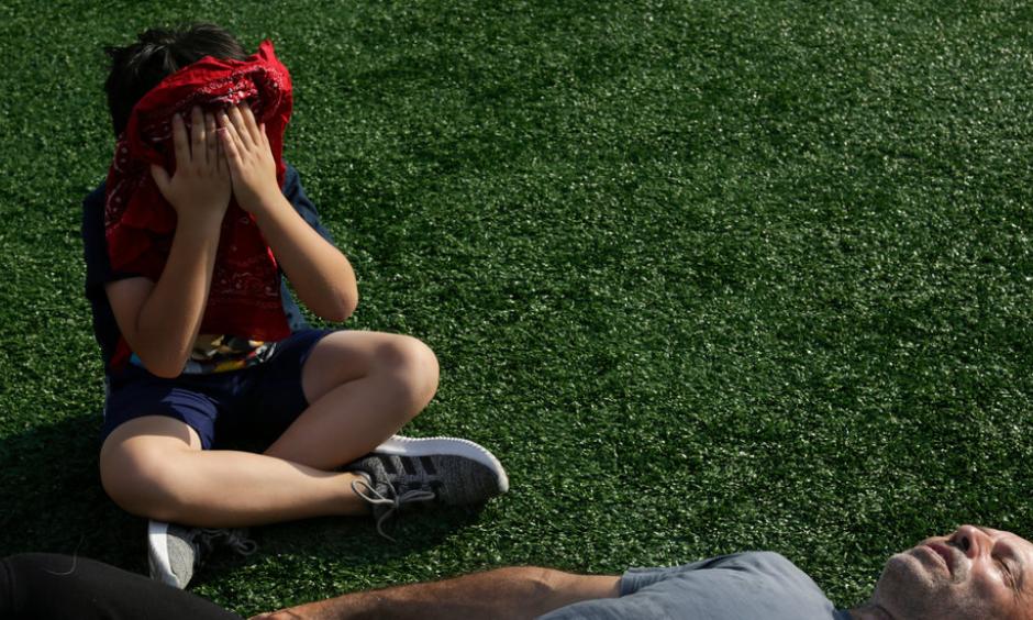 Milo Maimone, 8, and his dad, Tony, rest after working out at the McCarren Park track in Brooklyn on Sunday. Credit: Gabriella Angotti-Jones for The New York Times