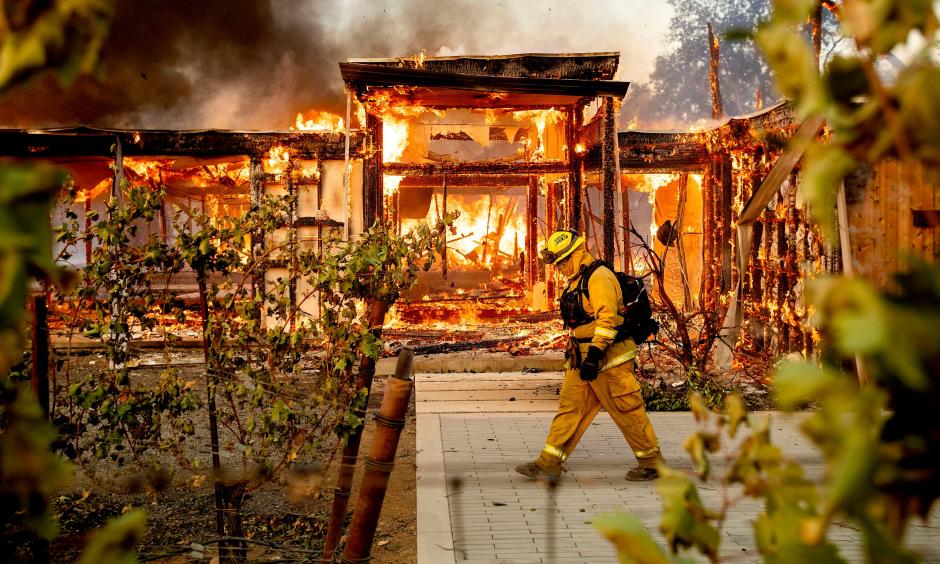 Firefighters try to save a home on Tigertail Road from the Getty fire, Oct. 28, 2019, in Los Angeles. Credit: USA Today