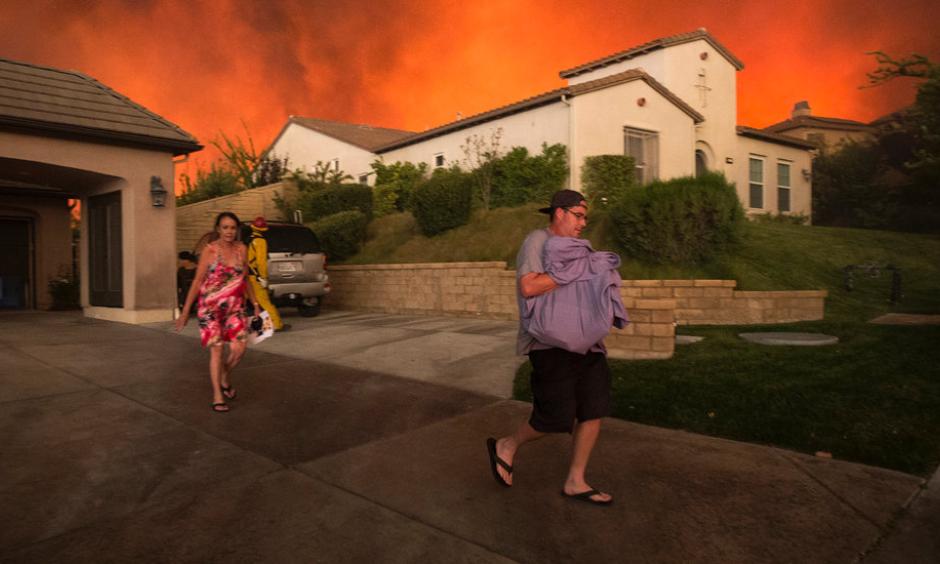 People left their homes on Saturday as a wildfire approached Santa Clarita, Calif. Photo: David Mcnew / Agence France-Presse / Getty Images