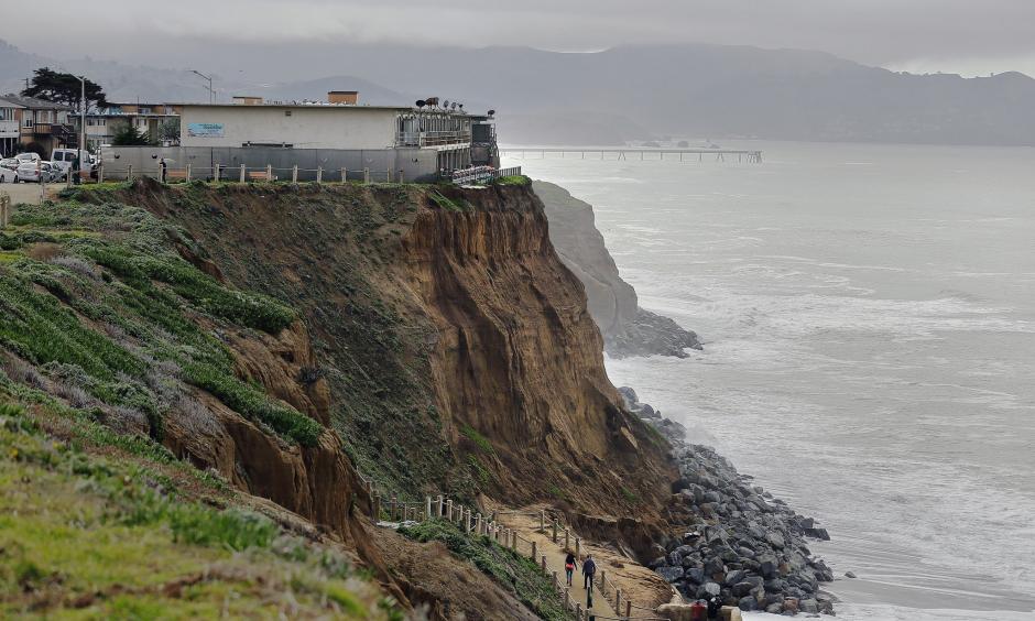 Apartments sit on the edge of an eroding coastal bluff in Pacifica, Calif. Photo: Eric Risberg, AP