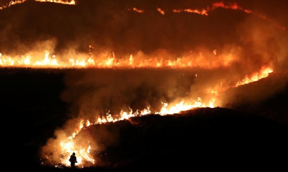 Firefighters tackled a blaze on Marsden Moor in northwest England that began on Tuesday night. Photo: Jon Super, Reuters
