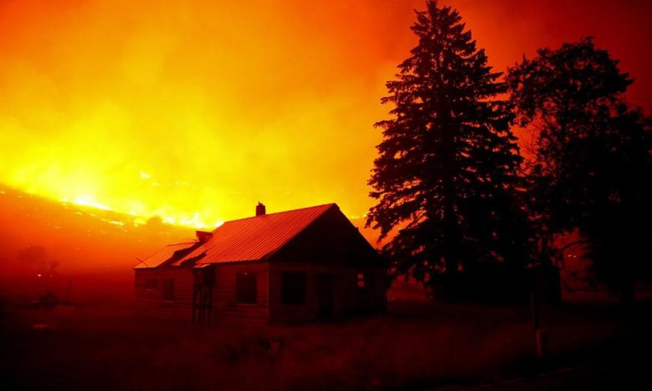 Flames blanket the hillsides on Twisp River Road just outside of the town of Twisp, Wash. last week. More than 900,000 acres have already burned this year in Washington wildfires. Photo: Erika Schultz, The Seattle Times